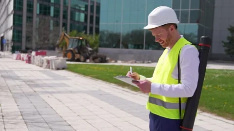 Quality Inspector Writing on Clipboard at Construction Site Stock Footage 278645140