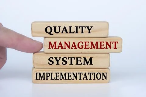 Quality Management System Implementation text on wooden blocks. Business cu.. Stock Photos