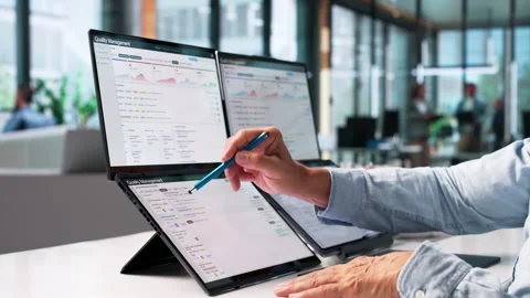 Quality Manager Reviews Compliance Data On Laptop 動画素材 345858127