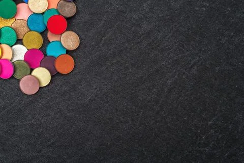 Quantity of round colorful eyeshadows on gray background Stock Photos