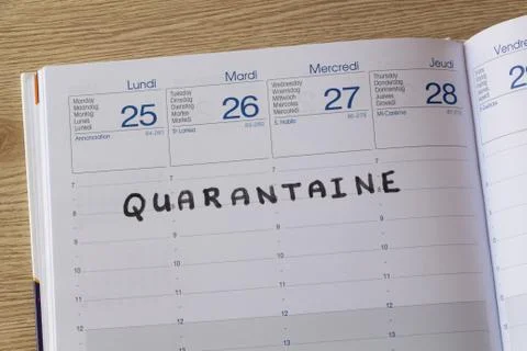 Quarantine written on a diary Stock Photos