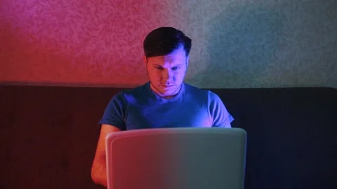Quarantined young man working remotely on a laptop. Stock Footage 131368056