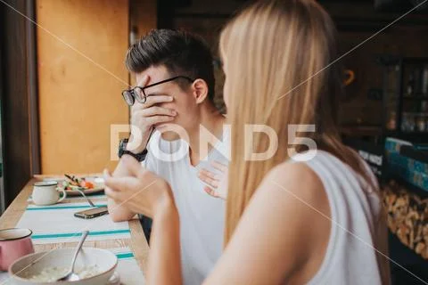 Quarrel between two young people in a coffee house, in a bar or restaurant Stock Photos