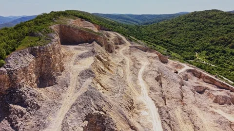 Quarry activity in a mountainous region with earth movement and landscaping Stock Footage 338276190