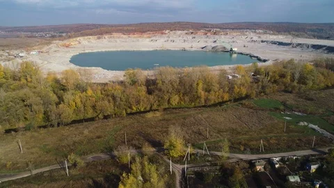 Quarry filled with water surrounded by a summer forest on a beautiful sunny day. Stock Footage 123896491