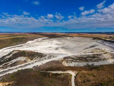 Quarry located in an open area showing layers of rock and earth under a blu.. Stock Photos