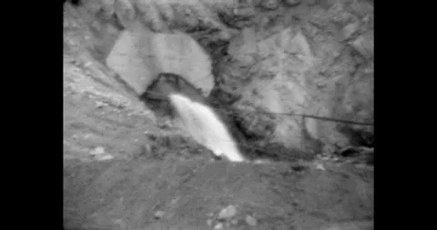 Quarry for mining rock, a powerful stream of water bursts out of the rock. A Vídeos de archivo 315661667