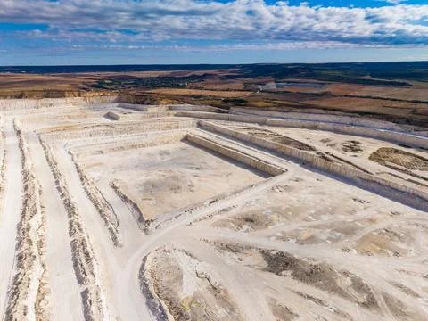 Quarry in an open landscape with bright sky and clear visibility of operati.. Stock Photos