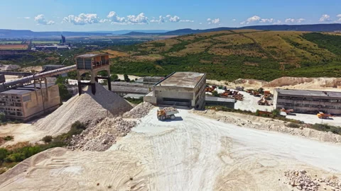 Quarry in operation with machinery and materials at a construction site during a Stock Footage 341074943