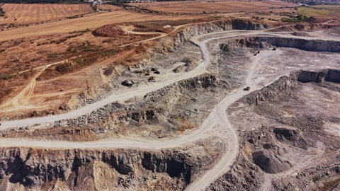 Quarry operation shows large machinery and rocky terrain in a mining site Stock Footage 344539414