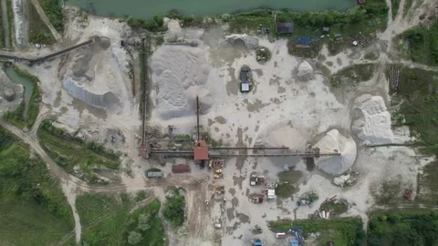 Quarry operations extracting sand and gravel from above with heavy machinery Stock Footage 347864567