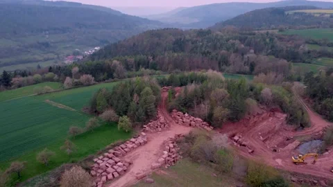 Quarry of red stone on a hill by the road and forest Stock Footage 154338215