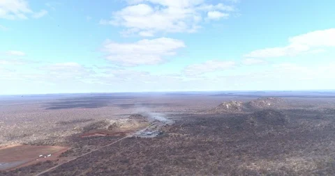 Quarry set in vast open African landscape seen from above with vultures Stock Footage 95918064