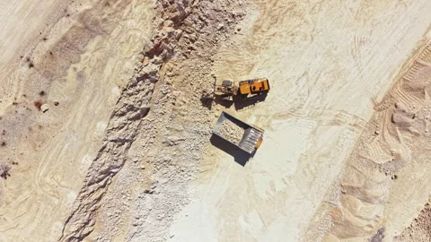 Quarry site with construction vehicles engaged in mining activity during Stock Footage 343575523