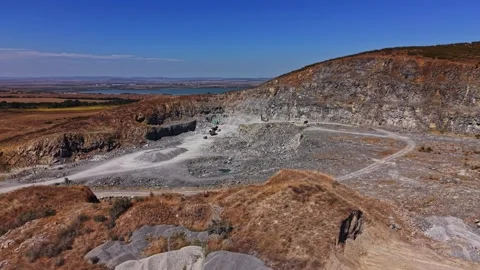 Quarry site with heavy equipment and terrain in use Stock Footage 344539005