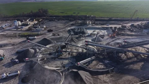 Quarry site with machinery working on material processing and transport Vídeos de archivo 329997828