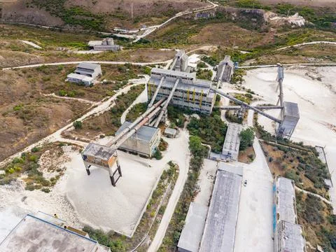 Quarry site in a remote location with various buildings and conveyor system.. Stock Photos