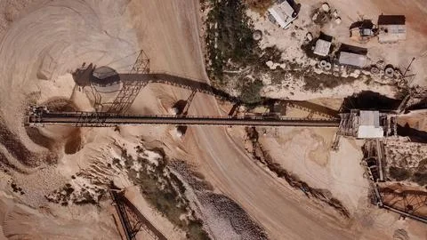 Quarry with Stone sorting conveyor belts and an open pit mine. Stock Photos