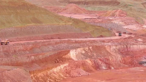 In a quarry, towards each other, two large mining dump trucks are moving. Stock Footage 122216025