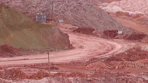 In a quarry, two large mining dump trucks are moving towards each other. Stock Footage 122216601