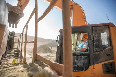 Quarry worker, in quarry, operating heavy machinery Stock Photos