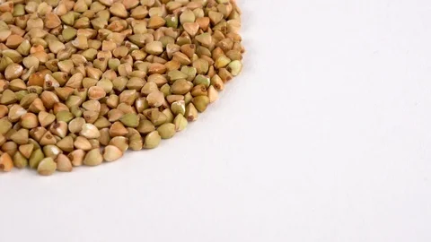 Quarter frame circle shaped heap of raw buckwheat rotating on turn table.  Stock Footage 88085293