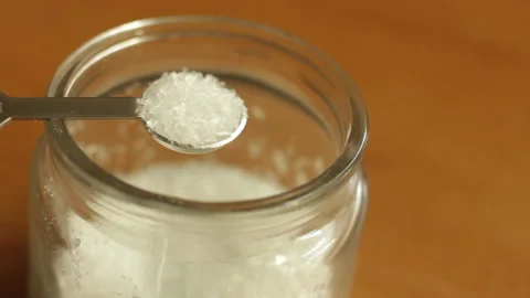 A quarter teaspoon of white refined MSG monosodium glutamate powder Stock Footage 222692162