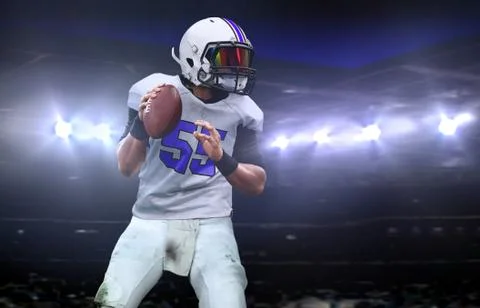 Quarterback  getting ready to throw a ball during a game at night Stock-Fotos