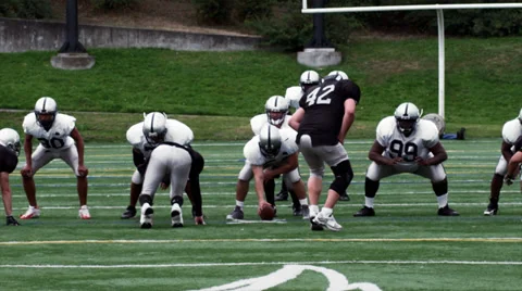 A Quarterback launches a deep pass to a receiver who drops it under pressure Stock Footage 33863886
