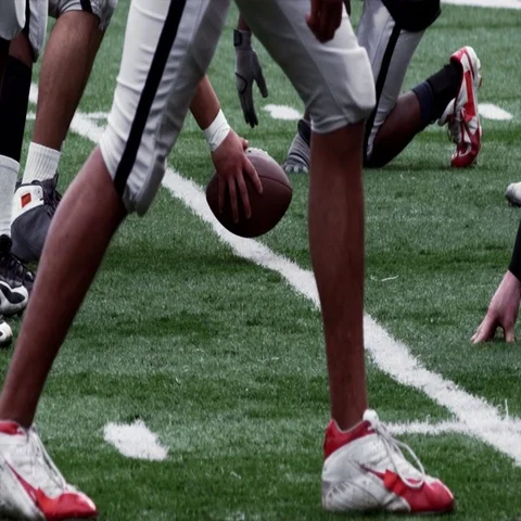 A Quarterback makes adjustments to the play at the line of scrimmage. Stock Footage 69378347