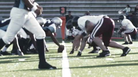 Quarterback pitches the ball to the running back as he gets tackled Stock Footage 33871083