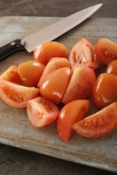 Quartered tomatoes Stock Photos