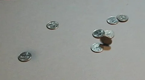 Quarters Falling onto a counter top Stockbeeldmateriaal 51824038