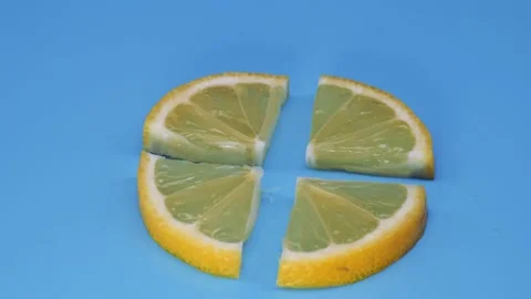 Quarters of a slice of lemon rotate in a plane. Stock Footage 157069527