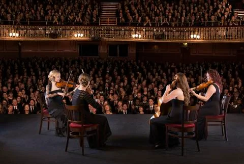 Quartet performing on stage in theater Stock Photos