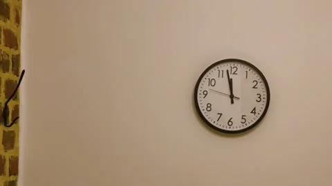 Quartz clock hangs on a white wall Stock Footage 337664051