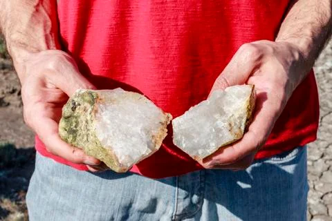 Quartz crystal stone split in half in hands Stock Photos