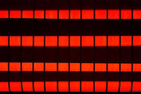 Quartz heater, red-hot elements under metal grid, close-up view. Stock Photos