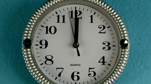 Quartz wall clock with second hand runs clockwise. The clock shows twelve oclock Stock Footage 149277325