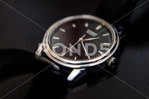 Quartz wristwatch with black dial close-up Stock Photos