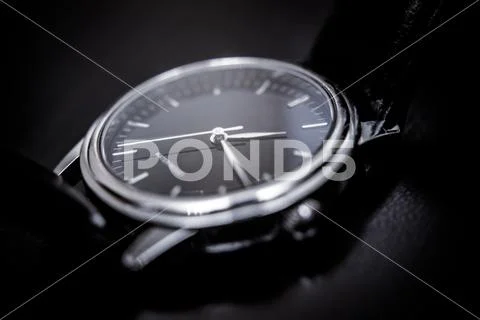 Quartz wristwatch with black dial close-up Stock Photos