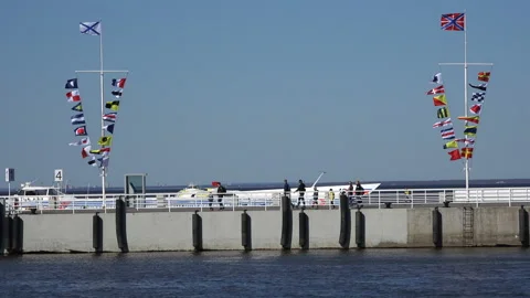 On the quay flags develop from the wind Stock Footage 94881871