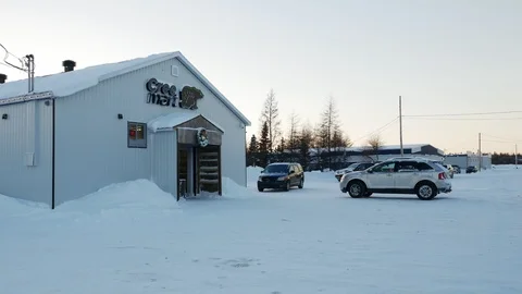 QUEBEC, CANADA: 01/12/2017: Chisasibi, James Bay, man walks into grocery store Stock Footage 98748892