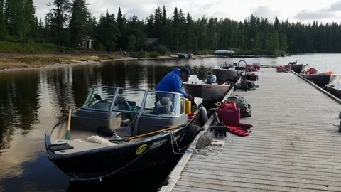 QUEBEC, CANADA: 08/14/2017: Cree man refuelling fishing boat, summer Stock Footage 98748844
