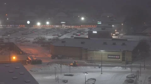 Québec, Canada Nov 3 '25 - plow grader clearing commercial lot blizzard Stock Footage 324862126
