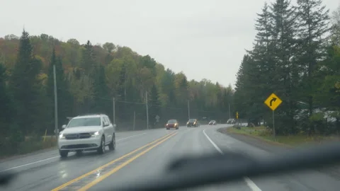 Quebec, Canada - Oct 11 2024: POV rainy windshield in autumn on highway Stock Footage 312771072