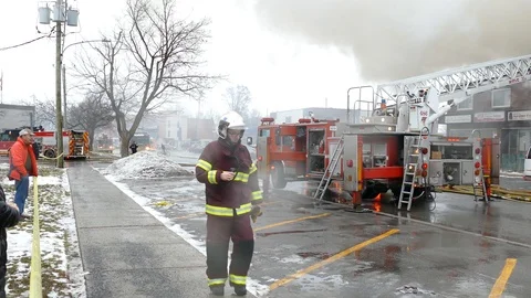 Quebec paramedic walking by fire scene with shiny silver helmet Stock-Footage 127256352