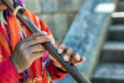 A Quechuan man in Cusco, Peru, playing the pinkullo, a wooden instrument si.. Stock Photos