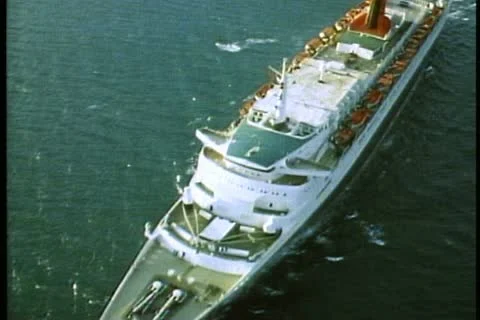 QUEEN ELIZABETH 2, 1985, Queen Elizabeth 2, QE2 aerial, ship passing under Stock-Footage 11611291