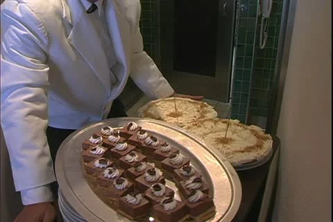 QUEEN MARY 2, 2004, Ocean liner, steward holding tray of desserts on the QM2 Stock Footage 20445531